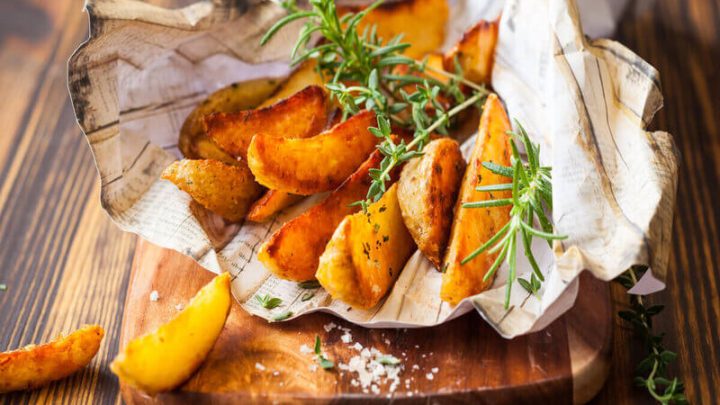 Batatas rústicas em cima de uma tábua de madeira