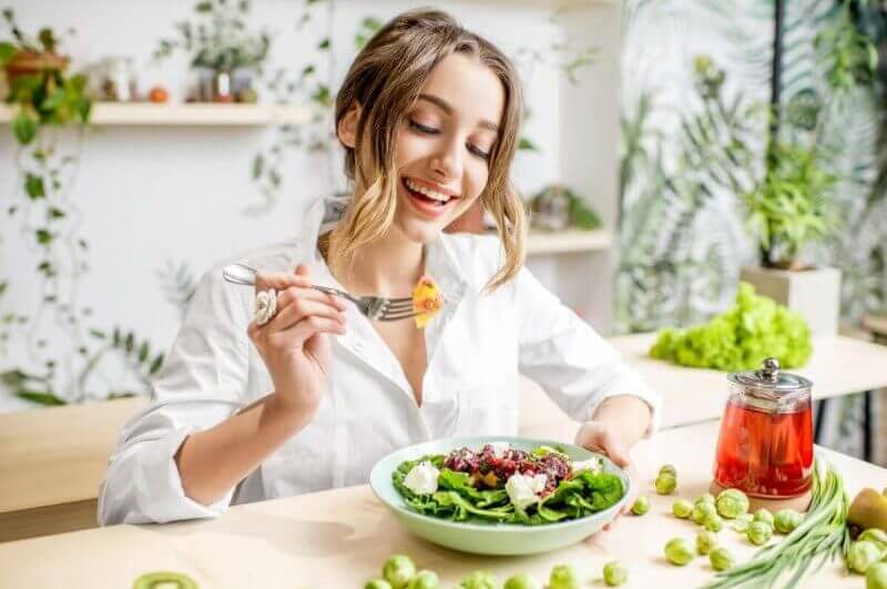 Mulher jovem comendo comida saudável