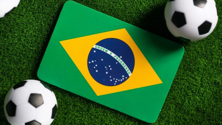 Bandeira do Brasil com duas bolas de futebol do lado