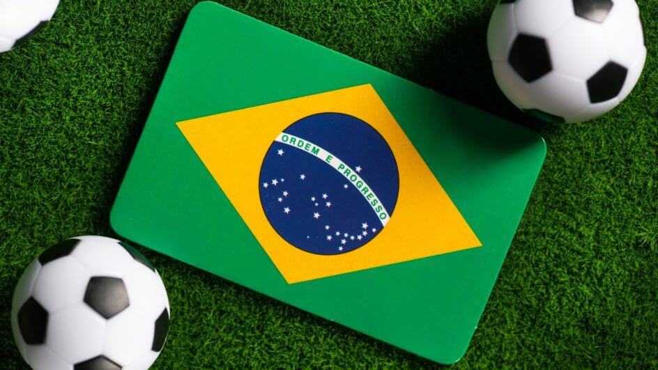 Bandeira do Brasil com duas bolas de futebol do lado
